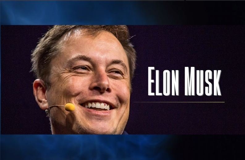 Elon Musk smiling on microphone