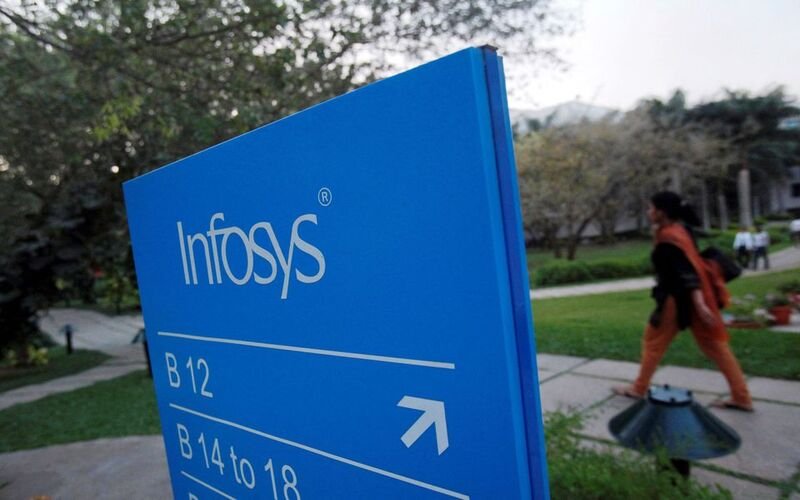 An employee walks past a signage board in the Infosys campus at the Electronics City IT district in Bangalore, February 28, 2012. REUTERS/Vivek Prakash/File Photo