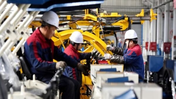 Employees work on a drilling machine production line at a factory in Zhangjiakou, Hebei province, China