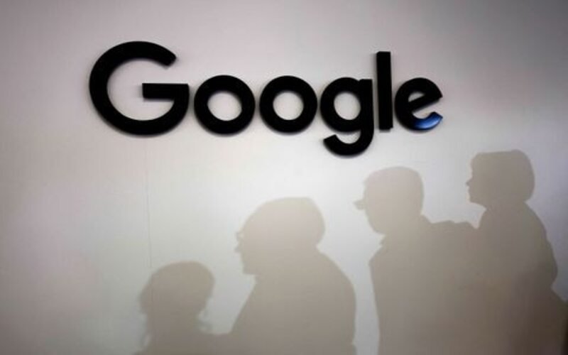 Visitors cast their shadows past the logo of Google at the Viva Technology conference dedicated to innovation and startups at Porte de Versailles exhibition center in Paris, France, June 15, 2023. REUTERS/Gonzalo Fuentes/File Photo