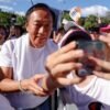 Supporters take a selfie with Terry Gou, the retired founder of major Apple supplier Foxconn