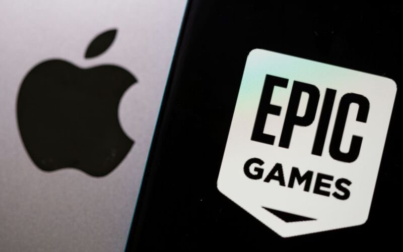 Smartphone with Epic Games logo is seen in front of Apple logo in this illustration taken, May 2, 2021. REUTERS/Dado Ruvic/Illustration