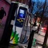 A man runs past a BP (British Petroleum) EV (Electric Vehicle) charge point in London, Britain, January 30, 2021. Picture taken January 30, 2021. REUTERS/Toby Melville