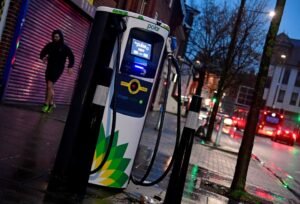 A man runs past a BP (British Petroleum) EV (Electric Vehicle) charge point in London, Britain, January 30, 2021. Picture taken January 30, 2021. REUTERS/Toby Melville