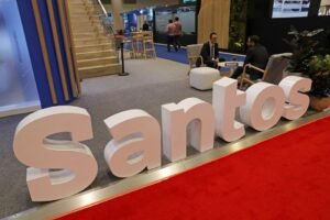 The logo of Australian oil and gas exploration and production company Santos is displayed during the LNG 2023 energy trade show in Vancouver, British Columbia, Canada, July 12, 2023. REUTERS/Chris Helgren/File Photo