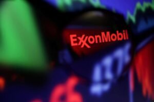 Exxon Mobil logo and stock graph are seen through a magnifier displayed in this illustration taken September 4, 2022. REUTERS/Dado Ruvic/Illustration/File Photo