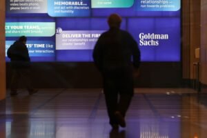 People walk in the Goldman Sachs global headquarters in Manhattan, New York, U.S., November 15, 2021. REUTERS/Andrew Kelly/File Photo