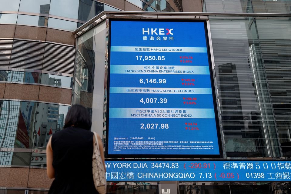 A screen showing the Hang Seng stock index is seen outside Exchange Square, in Hong Kong, China, August 18, 2023. REUTERS/Tyrone Siu/File Photo