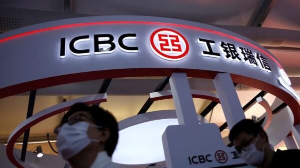People walk past a booth of ICBC Credit Suisse Asset Management Co at the 2020 China International Fair for Trade in Services (CIFTIS), in Beijing, China September 5, 2020. REUTERS/Tingshu Wang/File photo