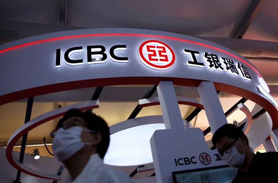 People walk past a booth of ICBC Credit Suisse Asset Management Co at the 2020 China International Fair for Trade in Services (CIFTIS), in Beijing, China September 5, 2020. REUTERS/Tingshu Wang/File photo