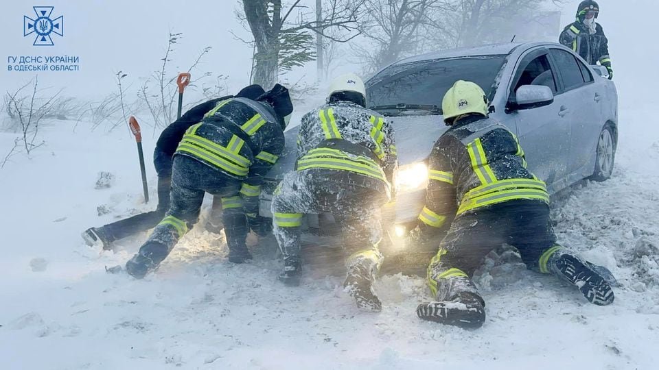 Emergency workers release a car which stuck in snow during a heavy snow storm in Odesa region, Ukraine in this handout picture released November 27, 2023. Press service of the State Emergency Service of Ukraine in Odesa region/Handout via REUTERS