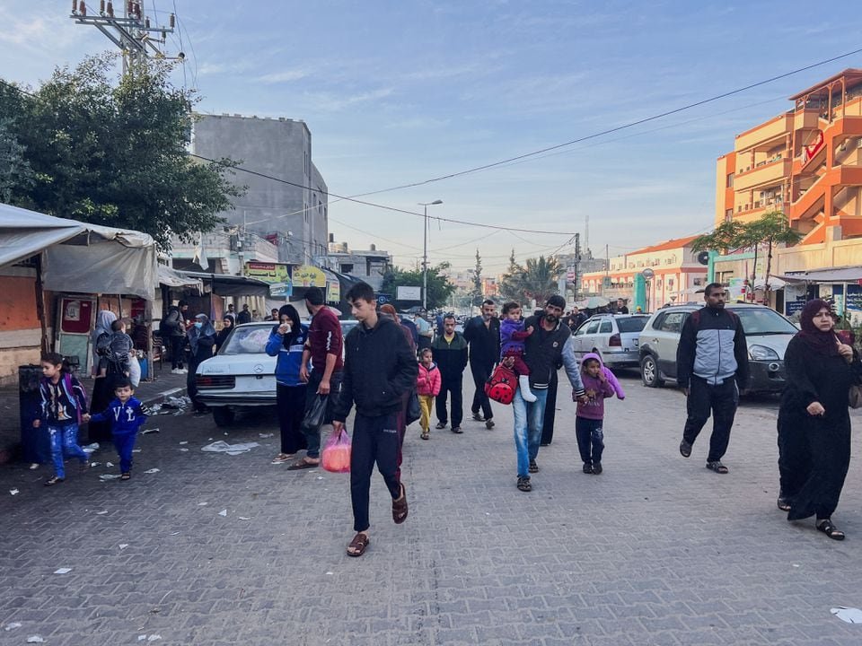 Palestinians walk on a street during a temporary truce between Hamas and Israel, in Khan Younis in the southern Gaza Strip, Novemeber 24, 2023. REUTERS/Saleh Salem