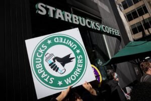 Members of the Starbucks Workers Union and other labor organization picket and hold a rally outside a company owned Starbucks store, during the coffee chain's Red Cup Day event in New York City, U.S., November 16, 2023. REUTERS/Brendan McDermid/File Photo