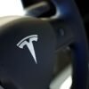 Tesla logo is seen on the steering wheel of an electric vehicle at a dealership in Durango, northern Spain, October 30, 2023. REUTERS/Vincent West