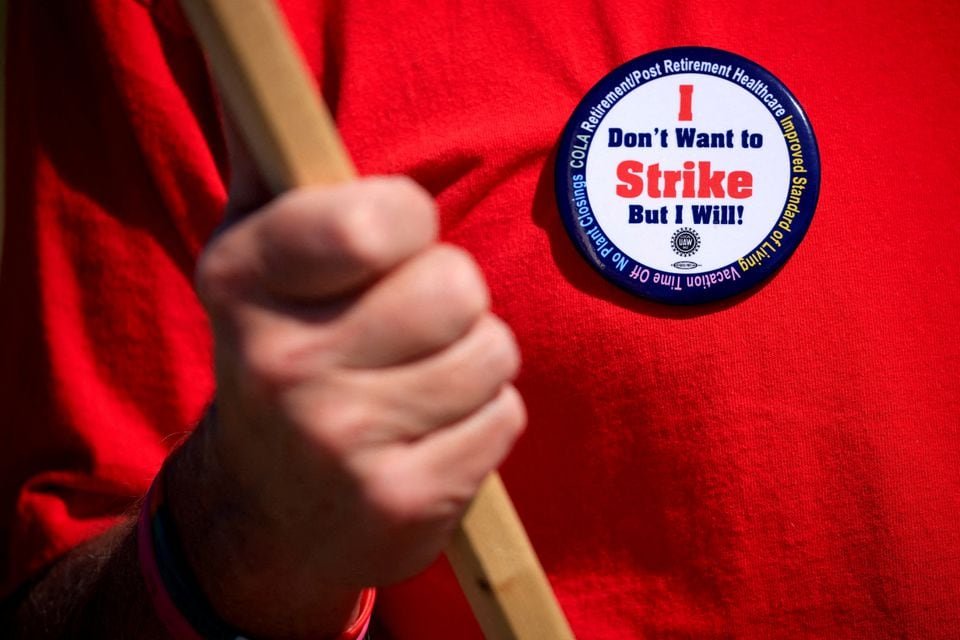 A United Auto Workers (UAW) union member wears a pin while picketing outside Ford's Kentucky truck plant after going on strike in Louisville, Kentucky, U.S. October 12, 2023. REUTERS/Luke Sharrett/File Photo