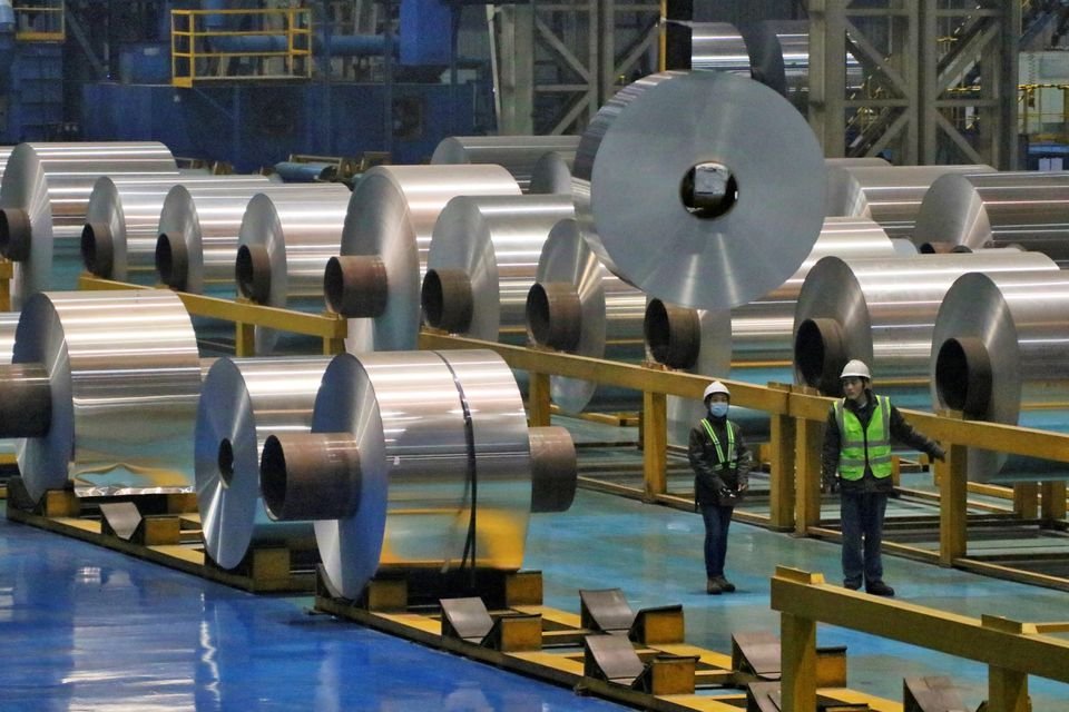 Employees work at the production line of aluminium rolls at a factory in Zouping, Shandong province, China November 23, 2019. Picture taken November 23, 2019. REUTERS/Stringer/File Photo