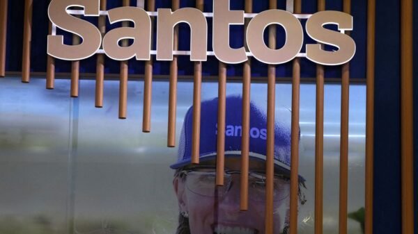 The logo of Australian oil and gas exploration and production company Santos is displayed during the LNG 2023 energy trade show in Vancouver, British Columbia, Canada, July 12, 2023. REUTERS/Chris Helgren/File Photo
