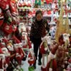 A vendor sorts products at a booth selling Christmas decorations at a mall in Beijing, China December 14, 2023. REUTERS/Tingshu Wang/File Photo