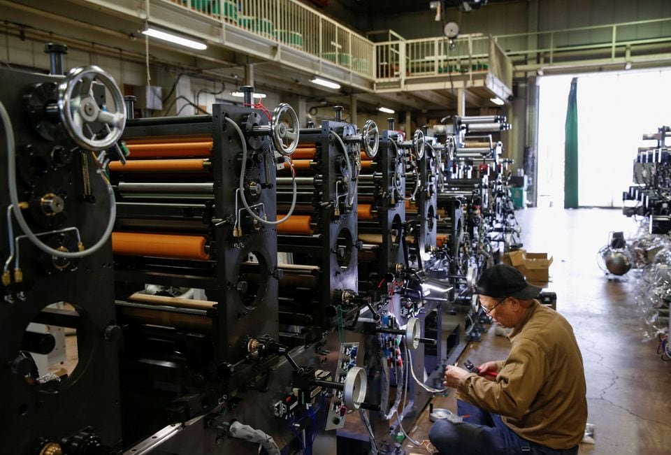 A worker checks machinery at a factory in Higashiosaka, Japan June 23, 2022. REUTERS/Sakura Murakami/File photo