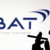 A woman poses with a cigarette in front of BAT (British American Tobacco) logo in this illustration taken July 26, 2022. REUTERS/Dado Ruvic/Illustration/File Photo
