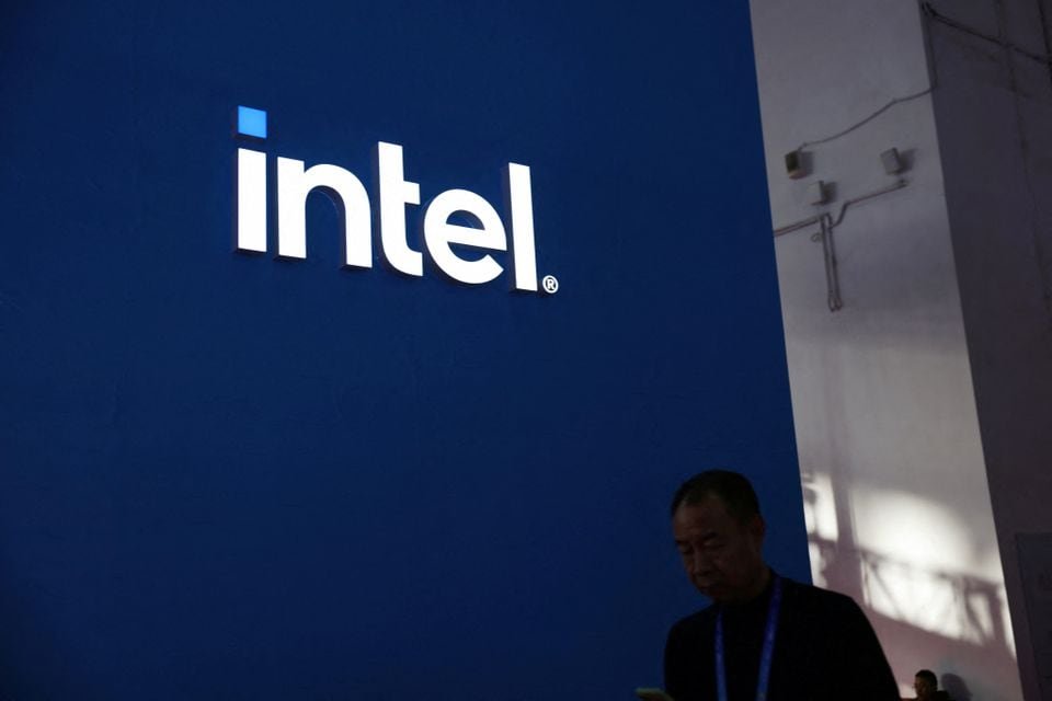 A man walks past the Intel logo at its booth during the first China International Supply Chain Expo (CISCE) in Beijing, China November 28, 2023. REUTERS/Florence Lo/File Photo