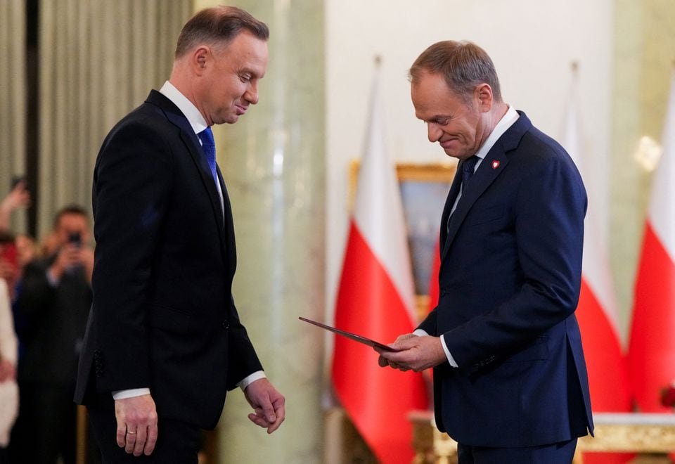 Polish President Andrzej Duda and newly appointed Polish Prime Minister Donald Tusk attend the cabinet swearing-in ceremony at the Presidential Palace in Warsaw, Poland December 13, 2023. REUTERS/Aleksandra Szmigiel