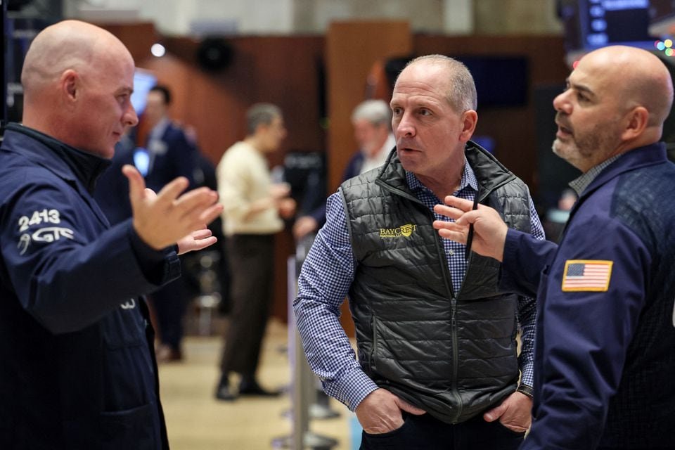 Traders work on the floor at the New York Stock Exchange (NYSE) in New York City, U.S., December 1, 2023. REUTERS/Brendan McDermid/File photo