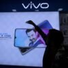 A man cleans a screen displaying a phone model of Chinese smartphone maker Vivo inside a shop in Ahmedabad, India, December 14, 2018 REUTERS/Amit Dave/File Photo