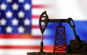 Oil pump jack is seen in front of displayed U.S. and Russian flags in this illustration taken, October 8, 2023. REUTERS/Dado Ruvic/Illustration/File Photo