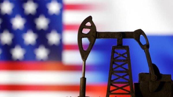 Oil pump jack is seen in front of displayed U.S. and Russian flags in this illustration taken, October 8, 2023. REUTERS/Dado Ruvic/Illustration/File Photo