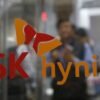 Employee walk past the logo of SK Hynix at its headquarters in Seongnam, South Korea, April 25, 2016. REUTERS/Kim Hong-Ji/File Photo