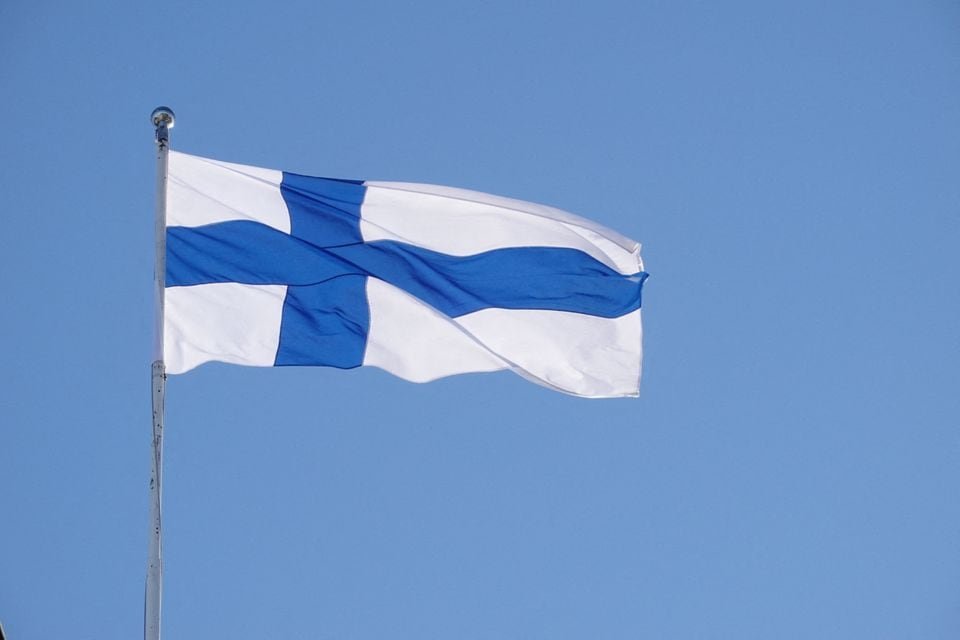 The Finnish flag flutters outside the city hall, as Finland becomes a member of NATO, in Helsinki, Finland, April 4, 2023. REUTERS/Tom Little/File Photo