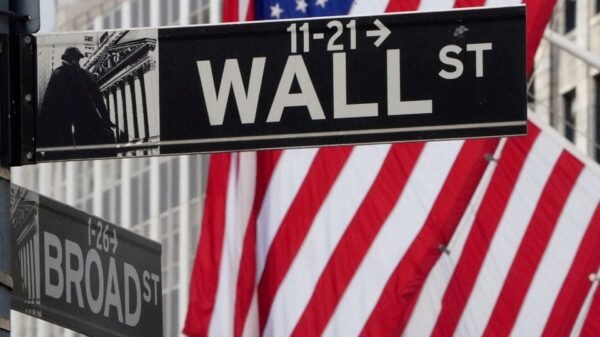 The Wall Street sign is pictured at the New York Stock exchange (NYSE) in the Manhattan borough of New York City, New York, U.S., March 9, 2020. REUTERS/Carlo Allegri/File Photo